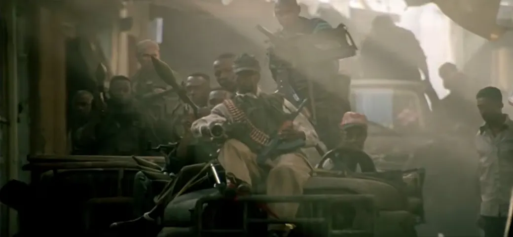 A convoy of Technicals rolls toward the Olympic Hotel as TF Ranger begins operations there. (from Black Hawk Down, Ridley Scott)