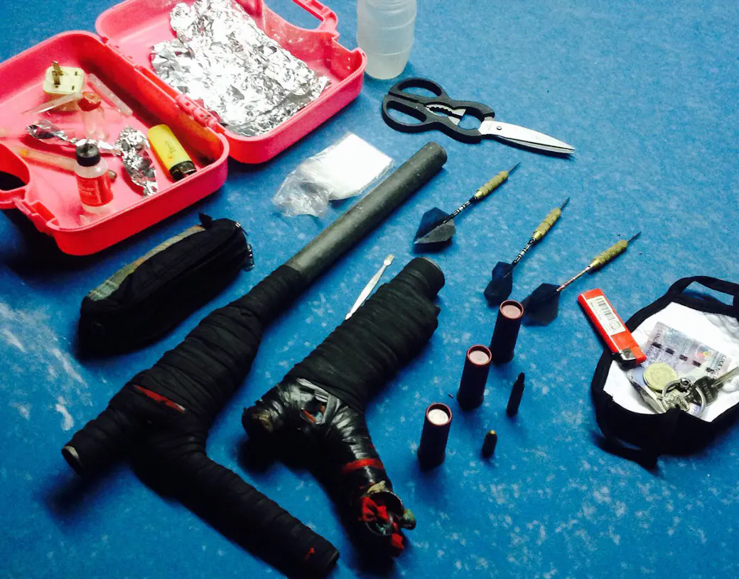 Two tape-wrapped homemade sumpak pipe guns, shotgun shells, and darts seized by Filipino police