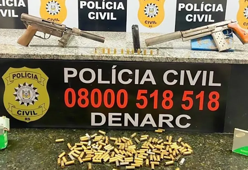 Two handmade suppressed submachine guns, a magazine, and loose ammunition displayed by Brazil’s Polícia Civil