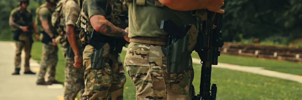 Line of men in military gear with T.REX Titan Level 2 Holsters on their belts
