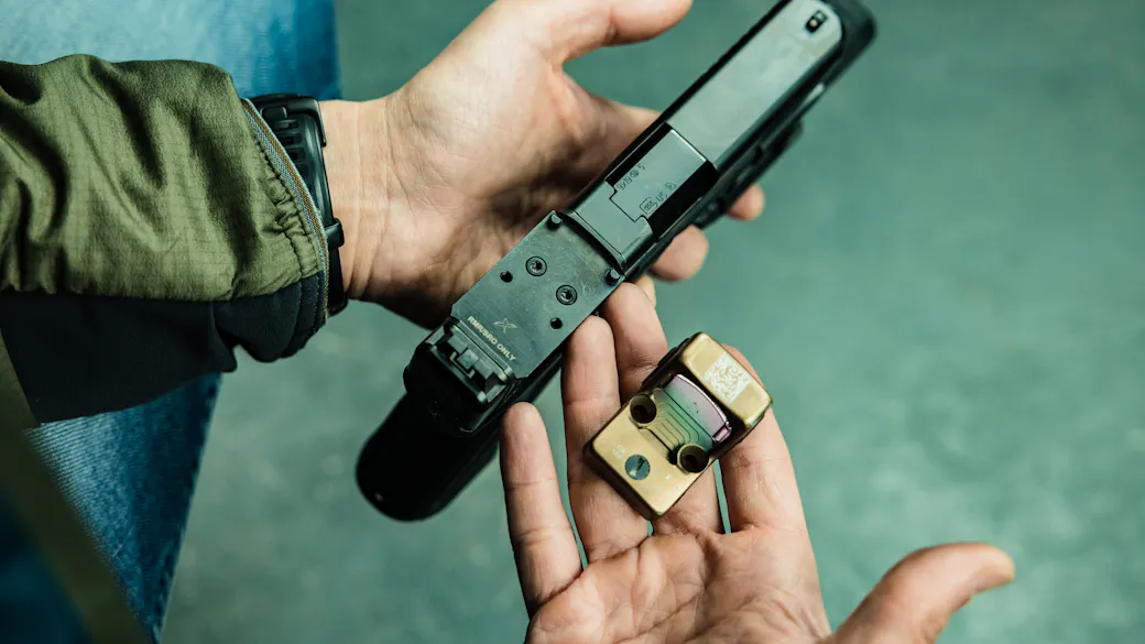 Pistol slide showing the optic cut and mounting footprint with screws visible
