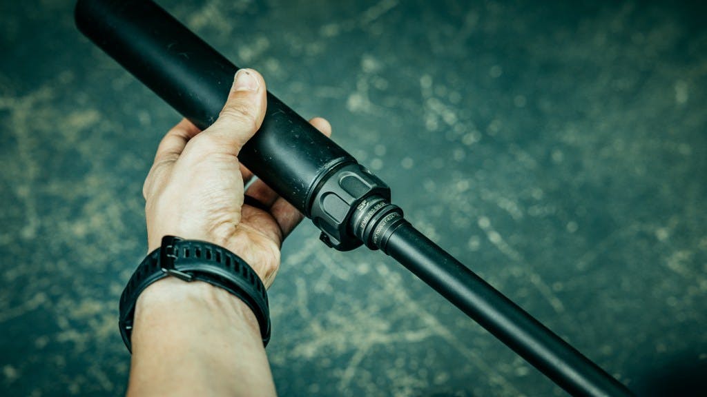 Surefire 762-RC2 suppressor being attached to a 5/8x24 SureFire Muzzle Brake