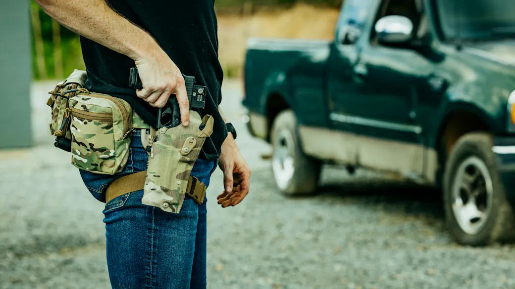 Safariland 6354RDS ALS Holster on a range belt setup with the shooter drawing their pistol from the holster