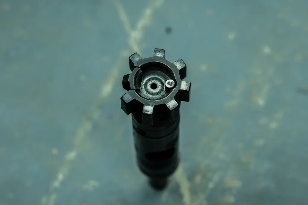 Heavily worn AR-15 bolt showing uneven lug wear